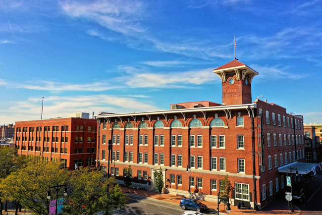 Historic Keen Kutter building in Wichita’s Old Town, with arched windows, clock tower, and brick facade.