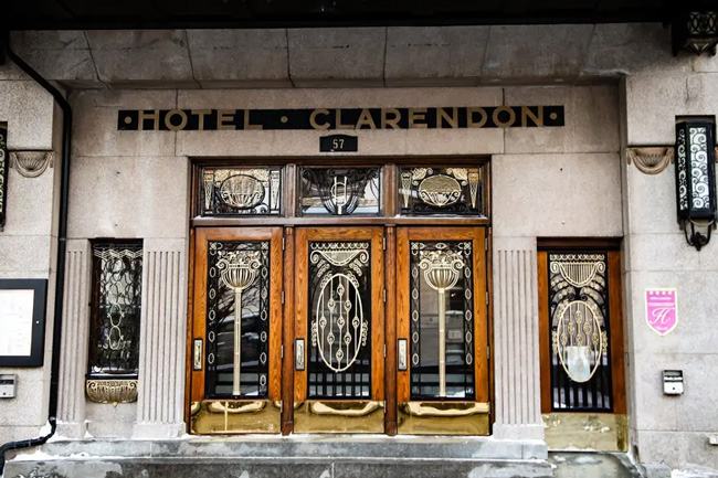 Hotel entrance with ornate doors and bold signage.